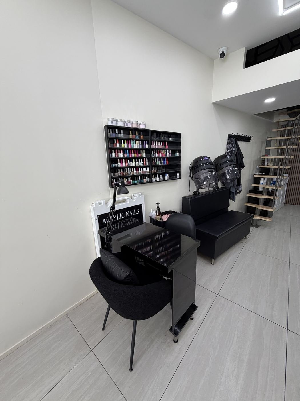 Acrylic nail station with polish wall at Barber & Blade, Hamilton Heights